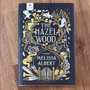 The Hazel Wood Novel with Gold and Black Cover